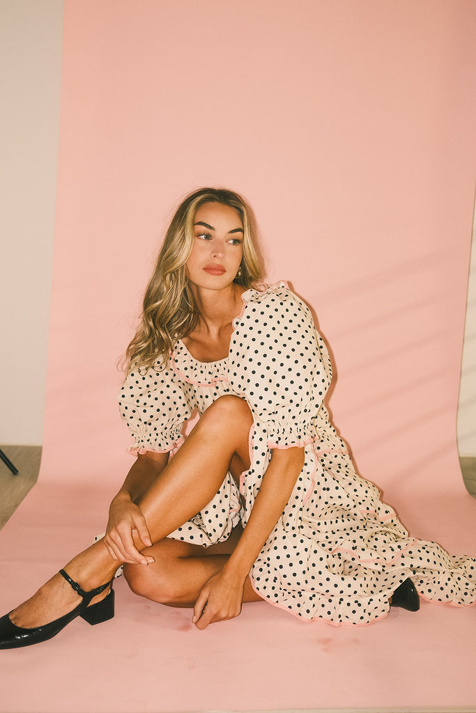 zoco daymaker dress: puff sleeve polka dot dress with an elastic neckline and pink trim details. perfect for weddings, baby showers, and family pictures.