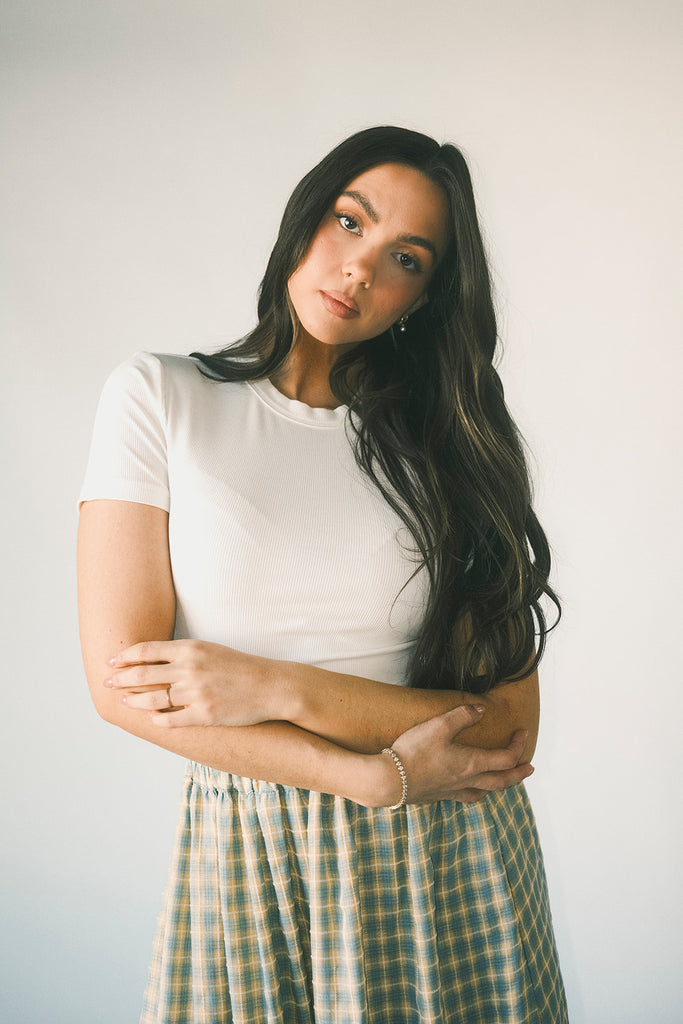 a classic plain white baby tee with a slightly cropped silhouette. the perfect fitted white t-shirt for everyday wear + casual outfit styling.
