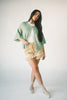 light green short sleeve cardigan with a slouchy, relaxed fit. perfect for casual outfits + lightweight layering.

