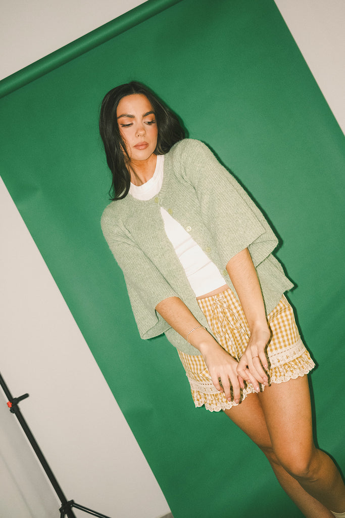 light green short sleeve cardigan with a slouchy, relaxed fit. perfect for casual outfits + lightweight layering.
