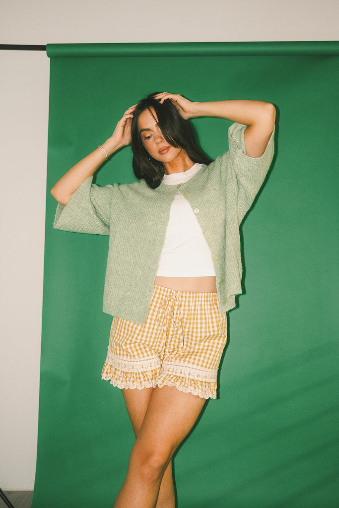 light green short sleeve cardigan with a slouchy, relaxed fit. perfect for casual outfits + lightweight layering.
