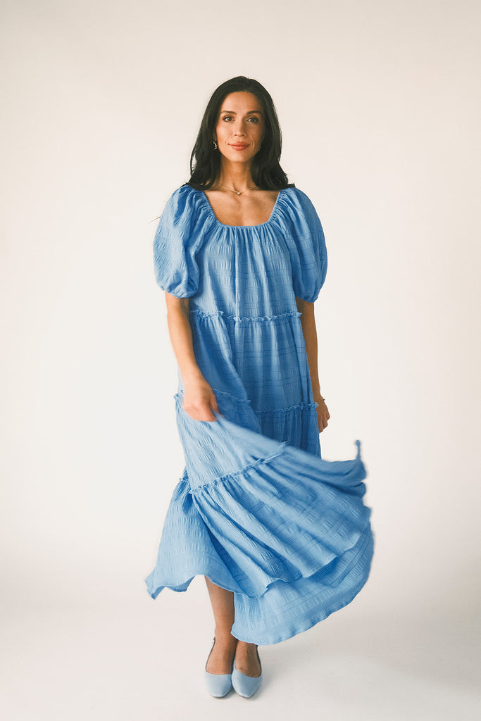 zoco daymaker dress: puff sleeve blue maxi dress with an elastic neckline. perfect for weddings, baby showers, and family pictures.
