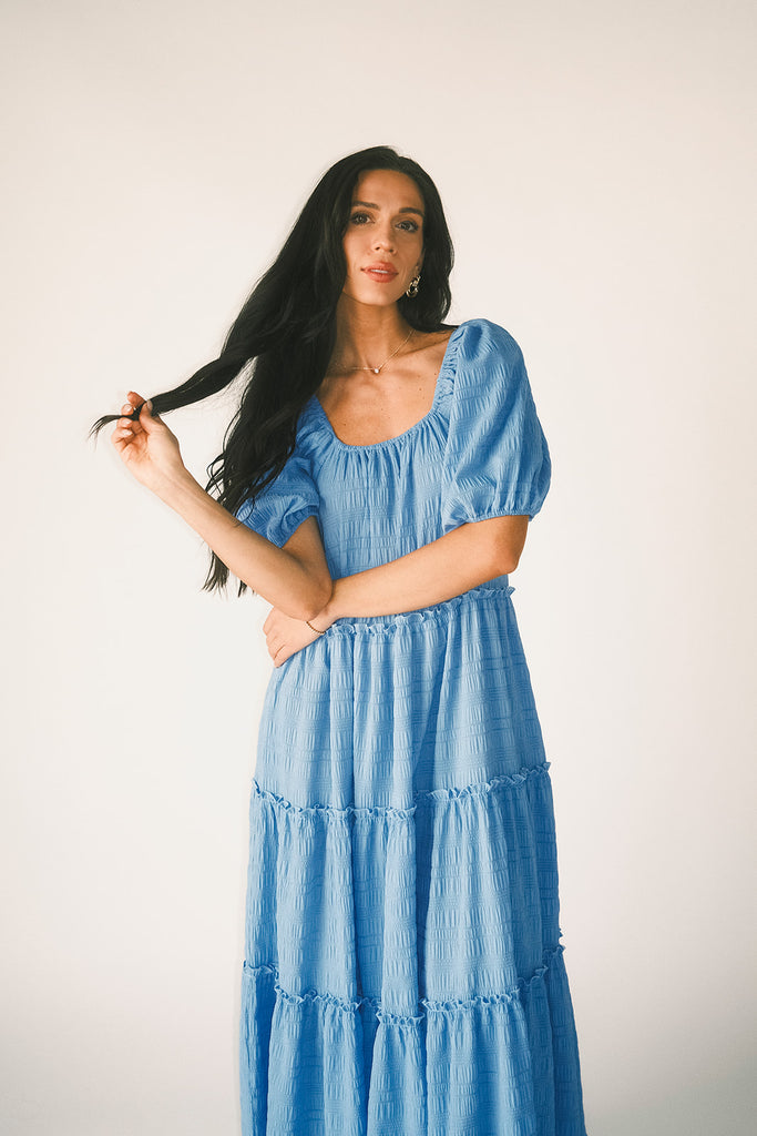 zoco daymaker dress: puff sleeve blue maxi dress with an elastic neckline. perfect for weddings, baby showers, and family pictures.
