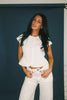 a white denim short sleeve top with a fitted silhouette + a peplum hemline. the perfect denim top to dress up or down for any outfit idea.
