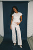 a white denim short sleeve top with a fitted silhouette + a peplum hemline. the perfect denim top to dress up or down for any outfit idea.
