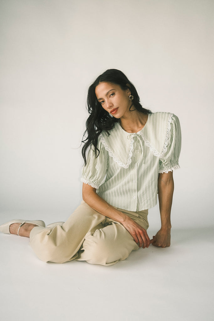 a vintage-inspired puff sleeve top with a pastel green pinstripe pattern + an oversized lace trim collar. the perfect elevated button up top for the office, dressy date nights, + everyday wear.
