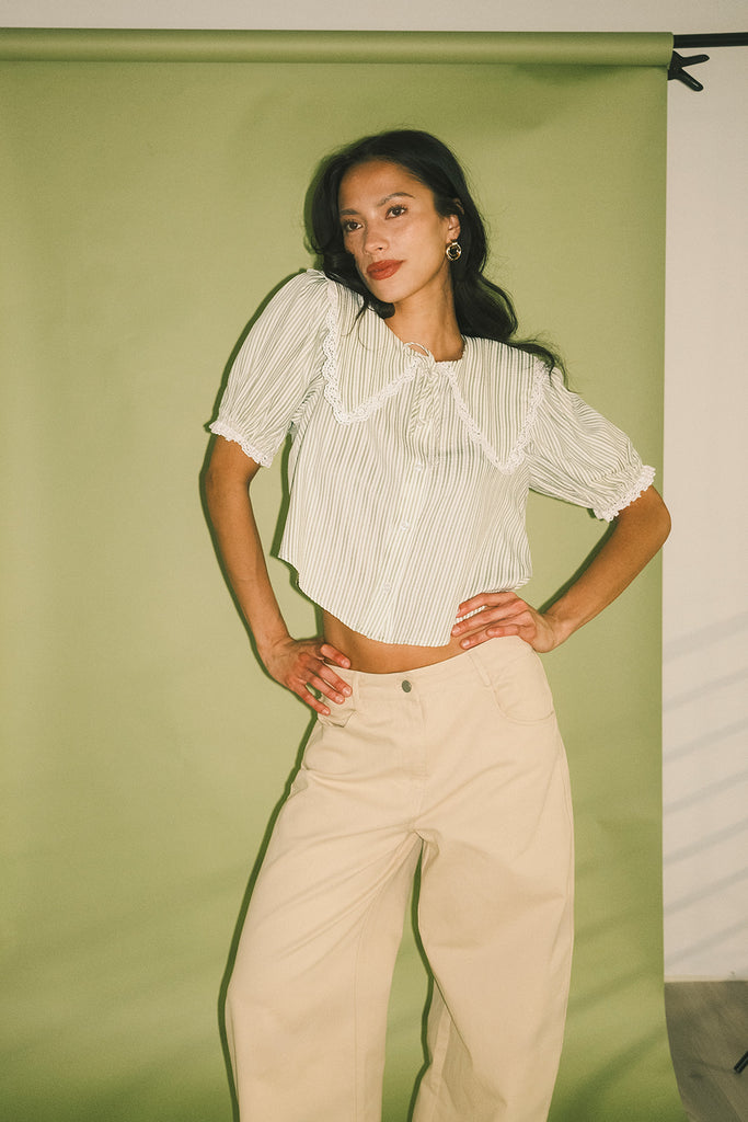 a vintage-inspired puff sleeve top with a pastel green pinstripe pattern + an oversized lace trim collar. the perfect elevated button up top for the office, dressy date nights, + everyday wear.

