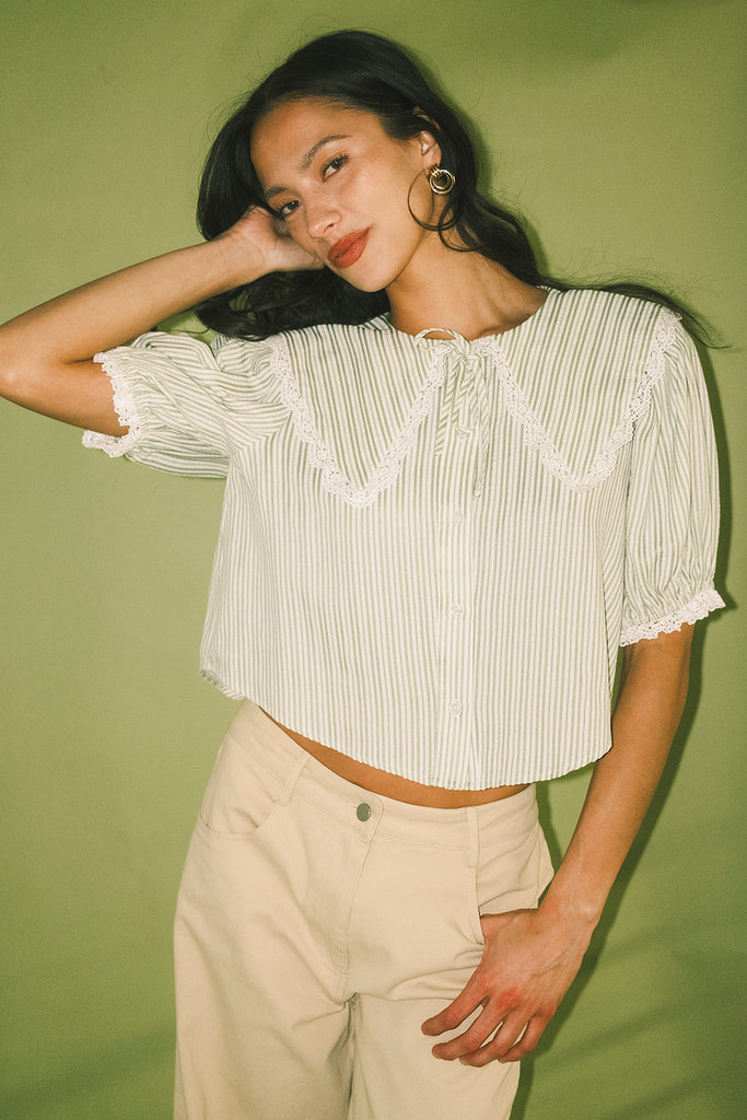 a vintage-inspired puff sleeve top with a pastel green pinstripe pattern + an oversized lace trim collar. the perfect elevated button up top for the office, dressy date nights, + everyday wear.
