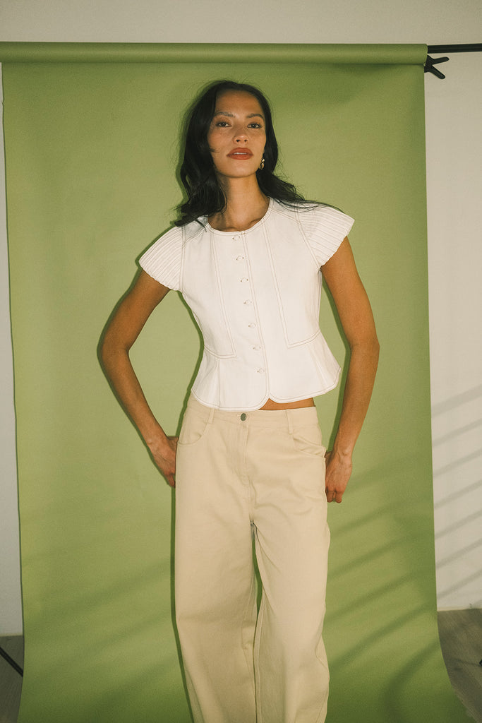 a white denim short sleeve top with a fitted silhouette + a peplum hemline. the perfect denim top to dress up or down for any outfit idea.
