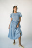 a puff sleeve blue gingham dress with a smocked bodice + side tie details. the perfect vintage-inspired dress for family pictures, weddings, + special occasions. 

