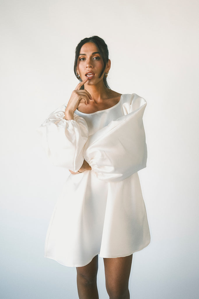a white satin mini dress with a vintage-inspired silhouette + long balloon sleeves. the perfect little white dress for graduations, bridal showers, + fancy dinner dates.
