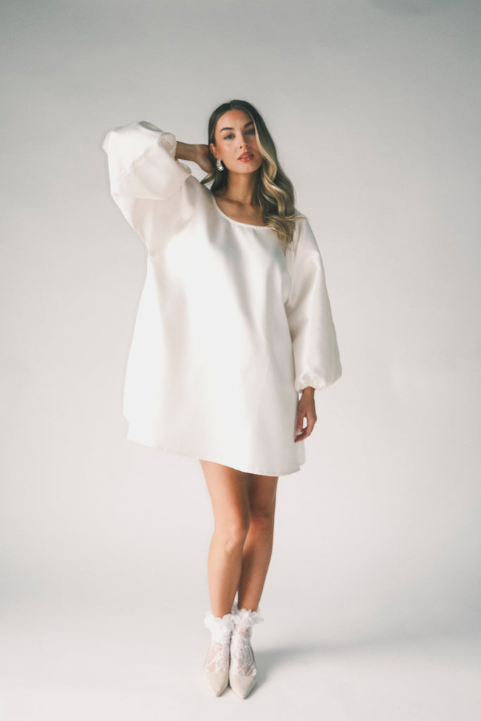 a white satin mini dress with a vintage-inspired silhouette + long balloon sleeves. the perfect little white dress for graduations, bridal showers, + fancy dinner dates.
