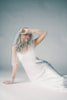 a white satin midi dress with lace detailing + a fitted silhouette. the perfect short sleeve occasion dress for weddings, bridal showers, + dinner parties.
