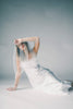 a white satin midi dress with lace detailing + a fitted silhouette. the perfect short sleeve occasion dress for weddings, bridal showers, + dinner parties.
