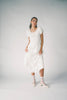 a white vintage-inspired midi dress with a lace ruffle neckline + bow detail. the perfect white dress for bridal showers, rehearsal dinners, + any special occasion.
