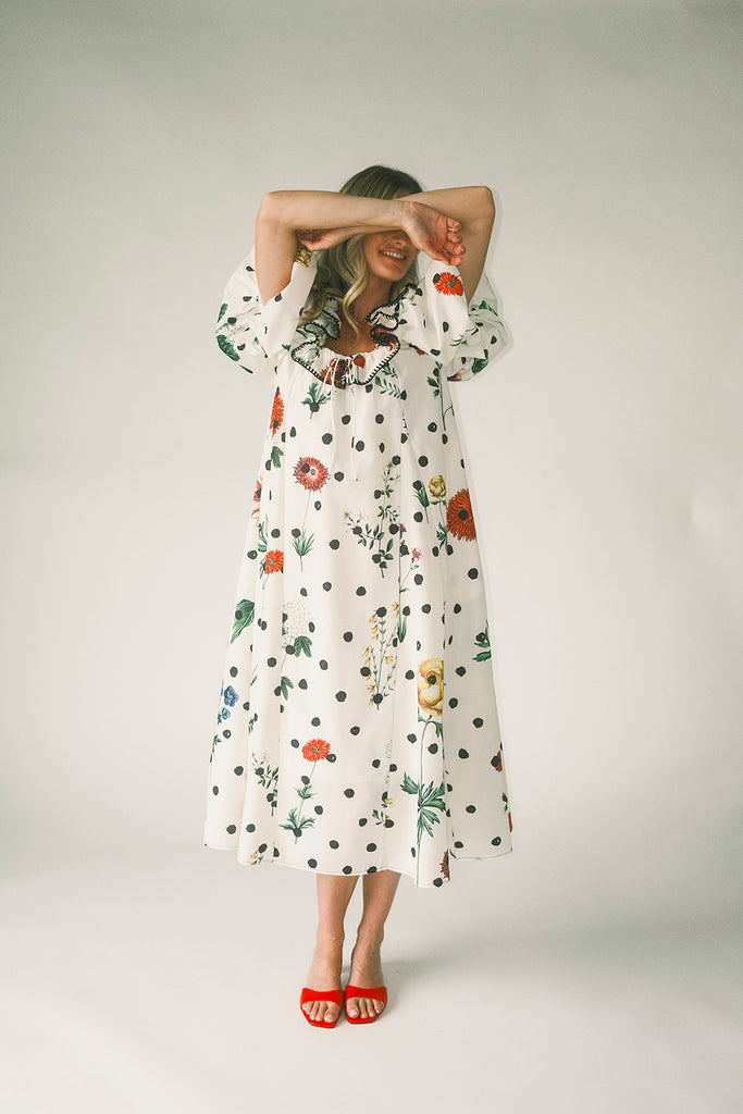 a polka dot puff sleeve dress with floral print details. the perfect polka dot midi dress for baby showers, family pictures, + special occasions. 
