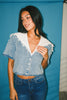 a short sleeve denim top with an oversized lace collar + a cropped silhouette. the perfect button up denim top to dress up or down for any outfit idea.
