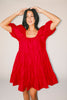 zoco daymaker dress: a short puff sleeve dress with an elastic neckline. the perfect red cotton dress for family pictures, weddings, and baby showers.
