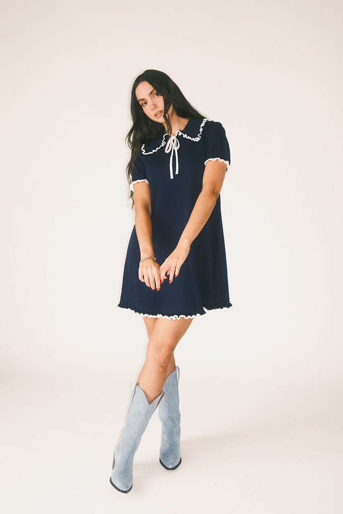 a short sleeve knit mini dress with a ruffled collar + bow detail. the perfect navy knit dress for date nights, family pictures, + everyday wear.
