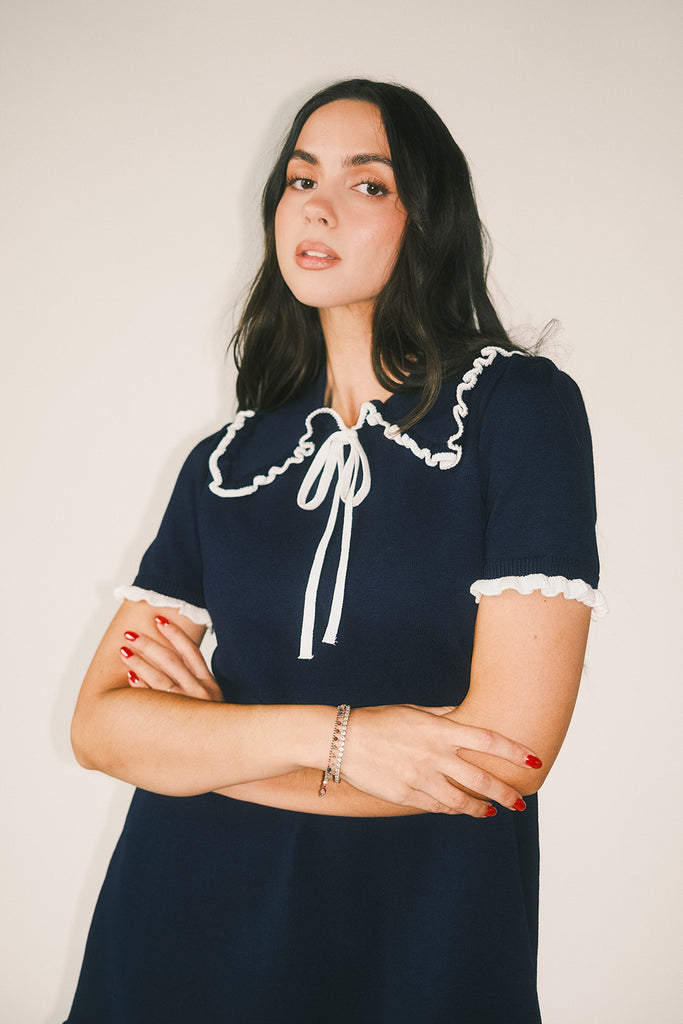 a short sleeve knit mini dress with a ruffled collar + bow detail. the perfect navy knit dress for date nights, family pictures, + everyday wear.
