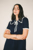 a short sleeve knit mini dress with a ruffled collar + bow detail. the perfect navy knit dress for date nights, family pictures, + everyday wear.
