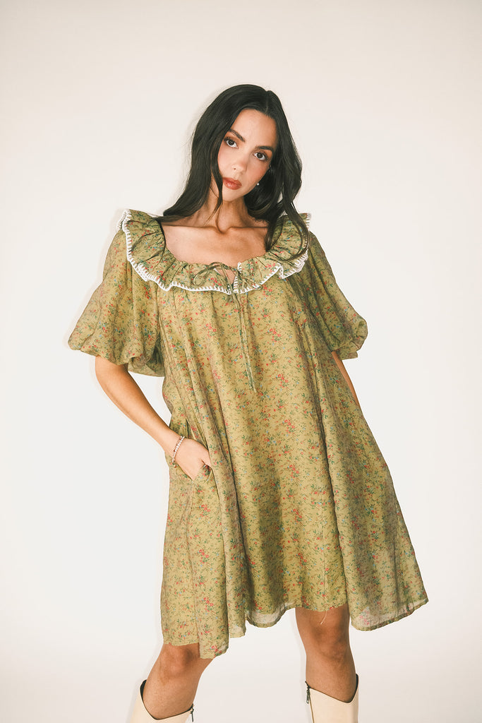 a green floral puff sleeve mini dress with a ruffle neckline. the perfect vintage-inspired dress for baby showers, family pictures, + special occasions. 
