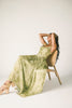 a flowy v-waist green dress with a sleek scoop neckline + subtle floral print. the perfect vintage-inspired maxi dress for weddings, bridal showers, + garden parties.
