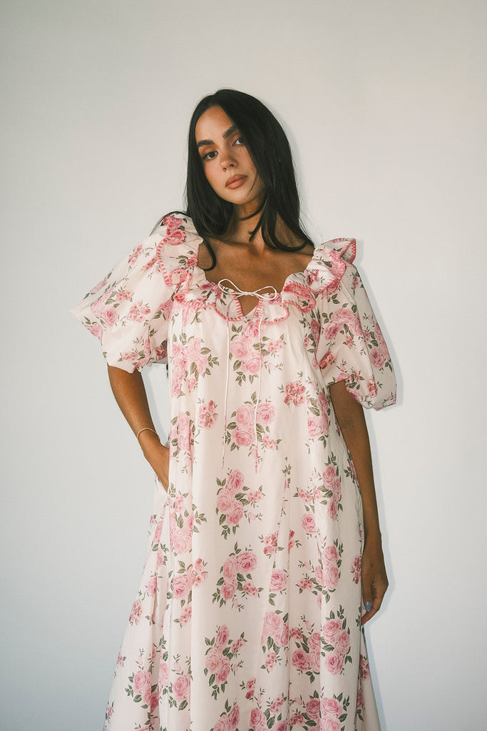 a pink floral puff sleeve dress with a ruffle neckline. the perfect vintage-inspired dress for baby showers, family pictures, + special occasions.
