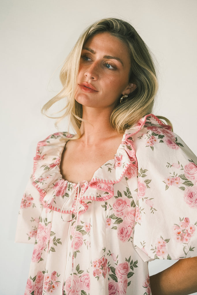 a pink floral puff sleeve dress with a ruffle neckline. the perfect vintage-inspired dress for baby showers, family pictures, + special occasions.
