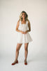 a white tank with a babydoll style silhouette + eyelet details. pair it with the matching white shorts to create the perfect two piece set for brunch dates, vacations, + everyday wear. 