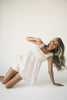 a white tank with a babydoll style silhouette + eyelet details. pair it with the matching white shorts to create the perfect two piece set for brunch dates, vacations, + everyday wear. 