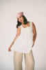 a white tank with a babydoll style silhouette + eyelet details. pair it with the matching white shorts to create the perfect two piece set for brunch dates, vacations, + everyday wear. 