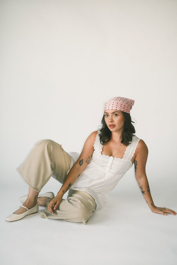 a white tank with a babydoll style silhouette + eyelet details. pair it with the matching white shorts to create the perfect two piece set for brunch dates, vacations, + everyday wear. 
