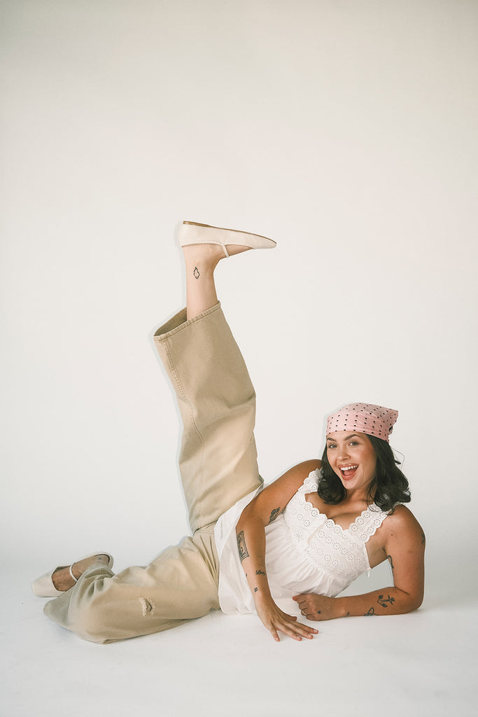 a white tank with a babydoll style silhouette + eyelet details. pair it with the matching white shorts to create the perfect two piece set for brunch dates, vacations, + everyday wear. 
