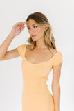 orange mini dress with a sweetheart neckline, ribbed texture, bodycon fit
