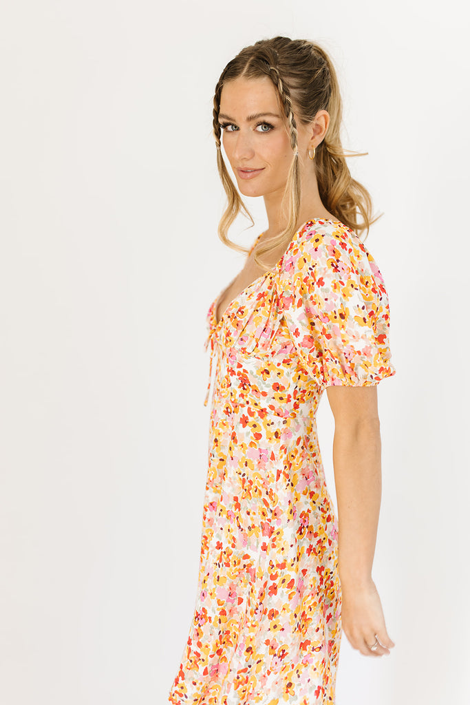 multicolor floral mini dress with a sweetheart neckline, working front tie, back zipper, balloon sleeves, and fully lined