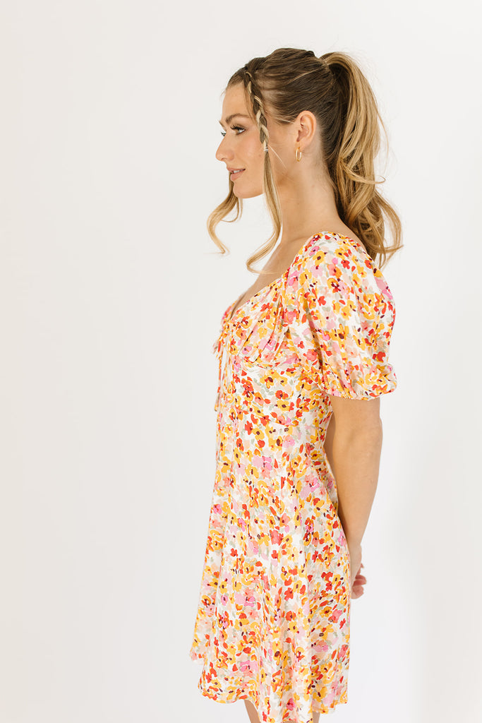 multicolor floral mini dress with a sweetheart neckline, working front tie, back zipper, balloon sleeves, and fully lined