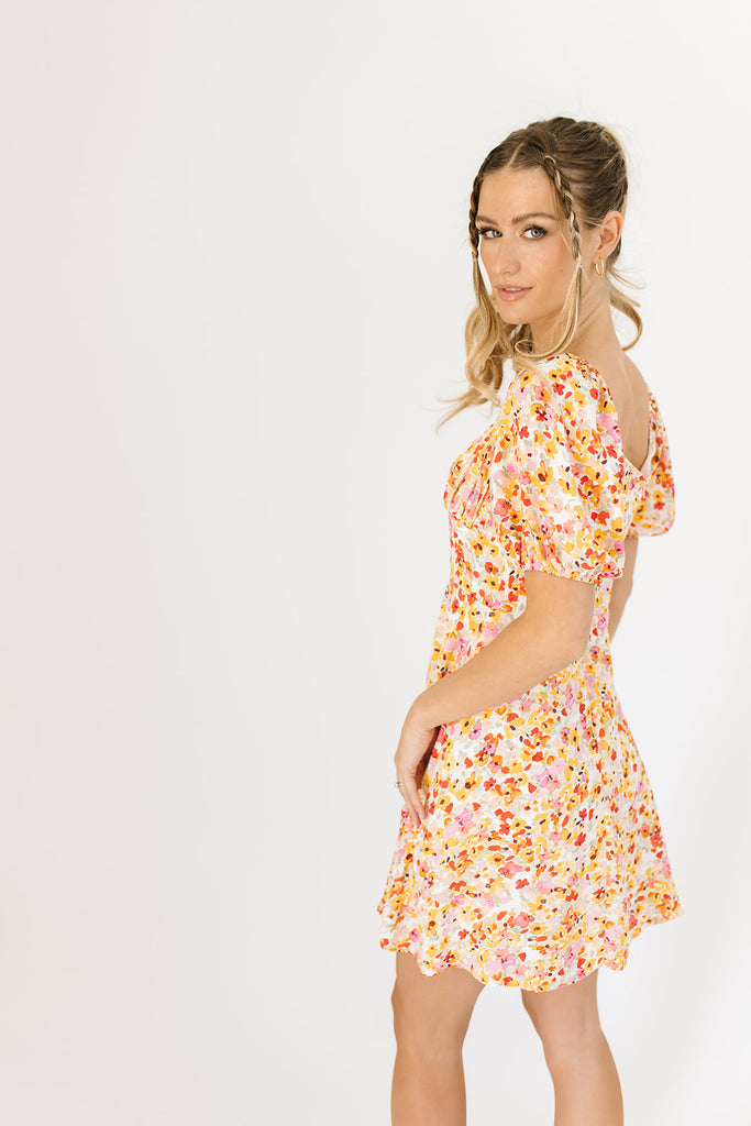 multicolor floral mini dress with a sweetheart neckline, working front tie, back zipper, balloon sleeves, and fully lined