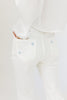 white denim with embroidered daisies, slight flare, one button zipper fly, pockets, and belt loops.